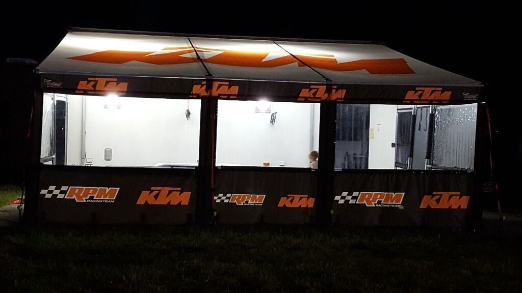 KTM RPM Racing Team trailer awning lit up at night